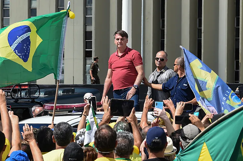 Brazilian President Jair Bolsonaro prepares to speak after joining his supporters who were taking part in a motorcade to protest against quarantine and social distancing measures to combat the new coronavirus outbreak in Brasilia on April 19, 2020. (Photo by EVARISTO SA / AFP)