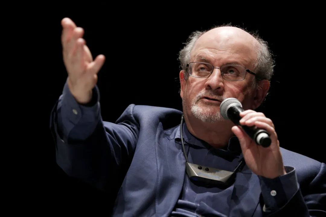 In this file photo taken on September 13, 2016, British writer Salman Rushdie speaks during the opening day of the Positive Economy Forum in Le Havre, northwestern France. - Rushdie, whose controversial writings made him the target of a fatwa that forced him into hiding, was stabbed in the neck by an attacker on stage Friday in western New York state, according to New York State Police. The attacked is in custody. (Photo by CHARLY TRIBALLEAU / AFP)