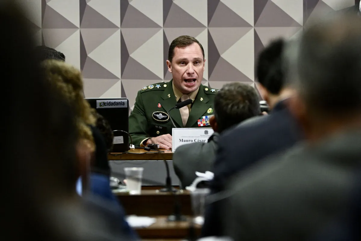 Brazil's Army Lieutenant Colonel Mauro Cid, aide-de-camp to former President Jair Bolsonaro, speaks during his testimony before the Parliamentary Inquiry Commission that investigates the acts of January 8, when an alleged coup attempt against Lula da Silva's government took place, at the National Congress in Brasilia on July 11, 2023. Brazilian police claimed that the military officer had "gathered documents with the objective of obtaining ?legal and judicial? support for the execution of a coup d?etat." (Photo by EVARISTO SA / AFP) / ?The erroneous mention[s] appearing in the metadata of this photo by EVARISTO SA                   has been modified in AFP systems in the following manner: [January 8] instead of January 9]. Please immediately remove the erroneous mention[s] from all your online services and delete it (them) from your servers. If you have been authorized by AFP to distribute it (them) to third parties, please ensure that the same actions are carried out by them. Failure to promptly comply with these instructions will entail liability on your part for any continued or post notification usage. Therefore we thank you very much for all your attention and prompt action. We are sorry for the inconvenience this notification may cause and remain at your disposal for any further information you may require.?
