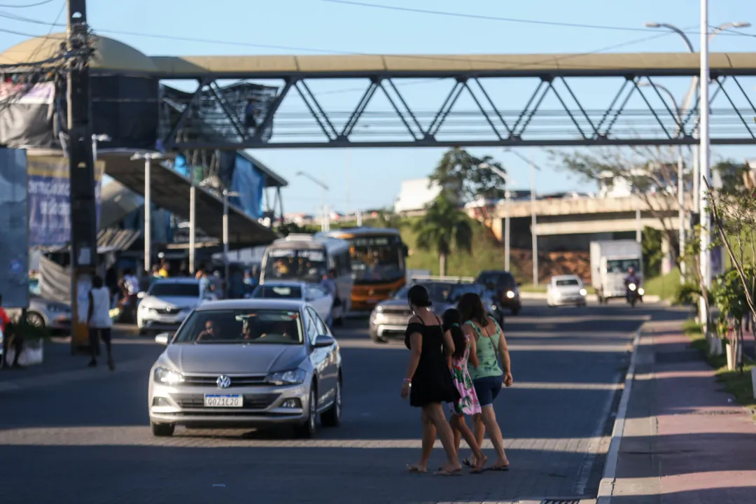 Pedestres atravessando a pista ao lado da passarela no bairro de São Cristóvão