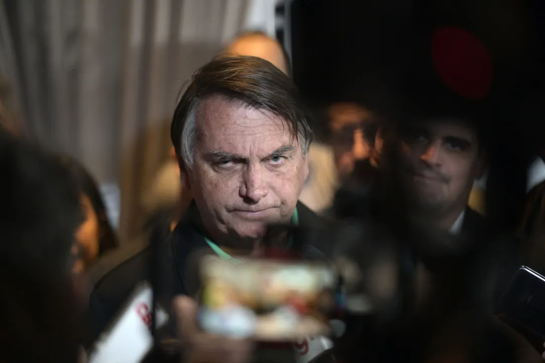 Former Brazilian President Jair Bolsonaro speaks to members of the media in Belo Horizonte, Minas Gerais state, Brazil, on June 30, 2023. Brazil's Superior Electoral Tribunal on Friday reached the majority it needs to bar far-right former president Jair Bolsonaro from politics for eight years over his unfounded claims against the voting system. (Photo by DOUGLAS MAGNO / AFP)