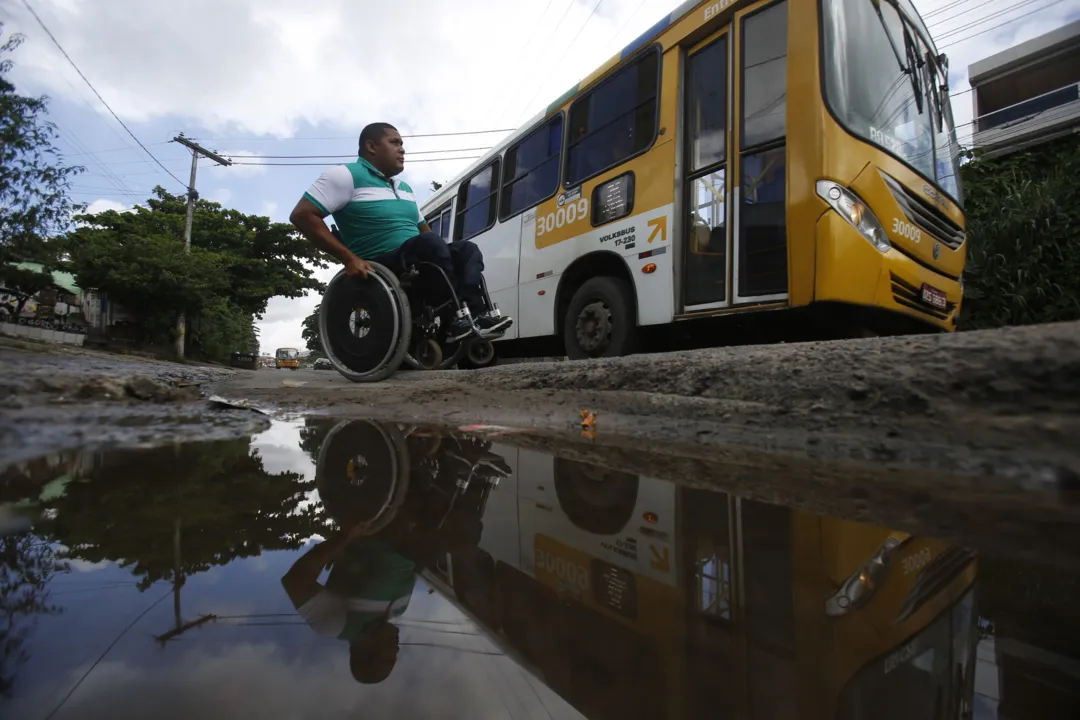 Passageiro com deficiência de locomoção tenta pegar ônibus coletivo