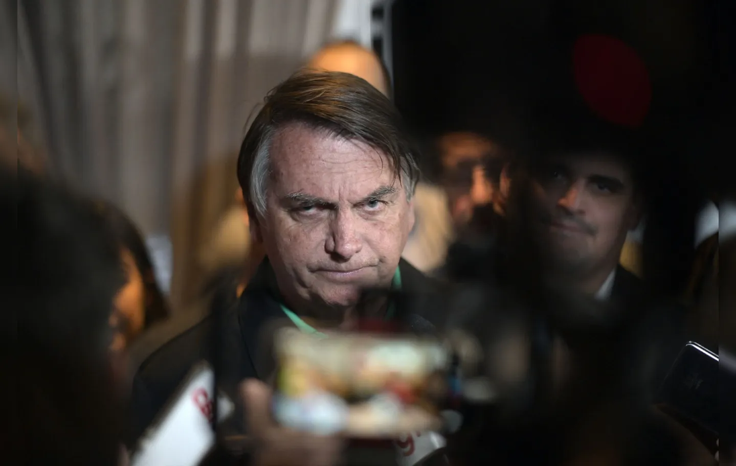 Former Brazilian President Jair Bolsonaro speaks to members of the media in Belo Horizonte, Minas Gerais state, Brazil, on June 30, 2023. Brazil's Superior Electoral Tribunal on Friday reached the majority it needs to bar far-right former president Jair Bolsonaro from politics for eight years over his unfounded claims against the voting system. (Photo by DOUGLAS MAGNO / AFP)