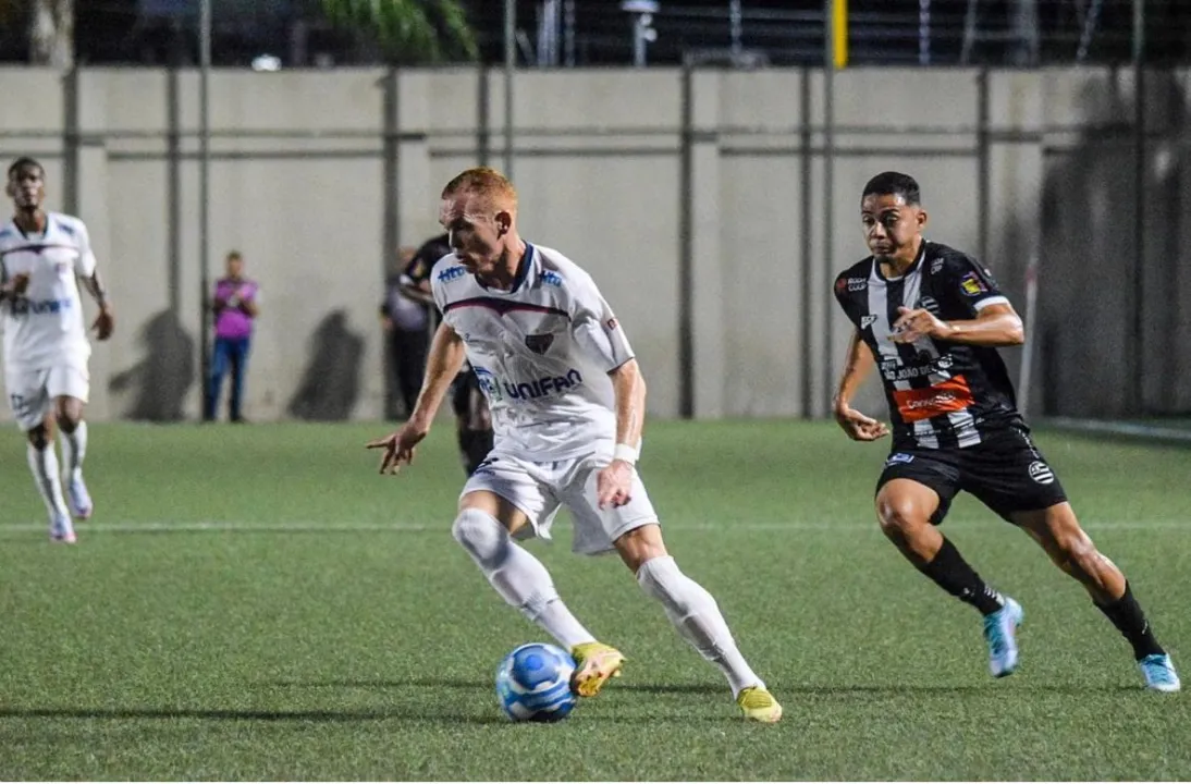 Na disputa o atacante Toni Galego tenta vencer a defesa do time mineiro