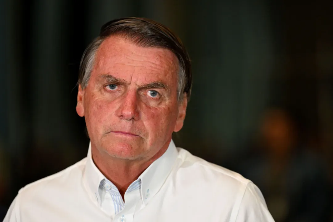 (FILES) Brazilian then President and re-election candidate Jair Bolsonaro gestures during a press conference at the Alvorada Palace in Brasilia, on October 26, 2022. Former Brazilian President Jair Bolsonaro denied on Wednesday July 12, 2023, his participation in an alleged plan to prevent the assumption of his successor, Luiz Inacio Lula da Silva, in statements at the Federal Police in Brasilia. (Photo by EVARISTO SA / AFP)