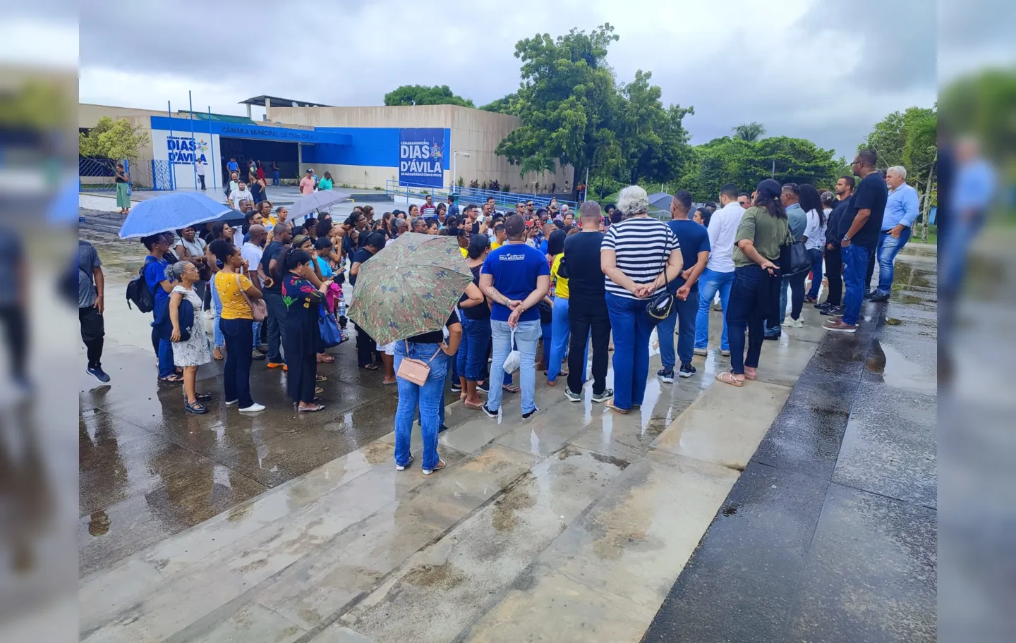 Professores se reúnem debaixo de chuva em frente à Câmara Municipal. Prefeitura negou espaço para assembleia.
