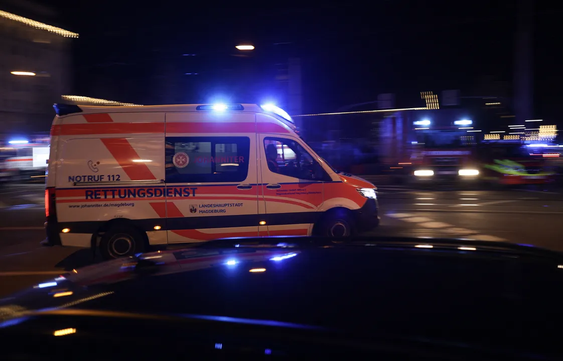 Ambulances rush to tho hospital after a car crashed into a crowd at a Christmas market injuring more than 60 people on December 20, 2024 in Magdeburg, eastern Germany. - The death toll of the Magdeburg market attack rose to two according to the State Premier. (Photo by Ronny HARTMANN / AFP)