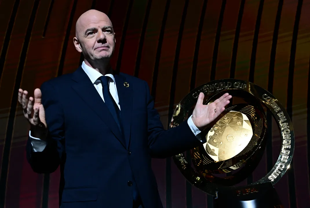 President of FIFA Gianni Infantino speaks next to the trophy during the 2025 FIFA Club World Cup Draw ceremony in Miami on December 5, 2024. (Photo by Giorgio VIERA / AFP)