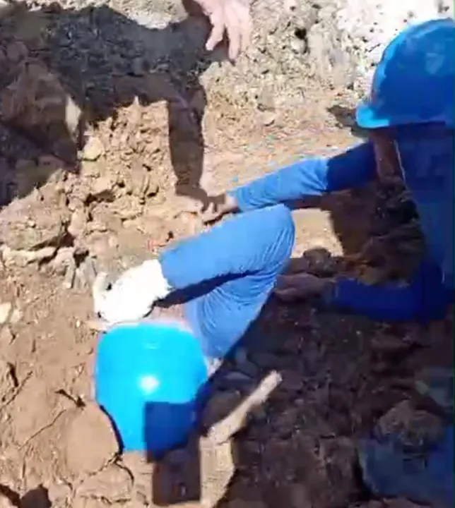 Homens fazem operação para salvar trabalhador soterrado