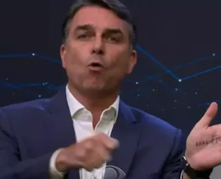 Flávio Bolsonaro faz cola na mão e provoca Lula no debate da Band