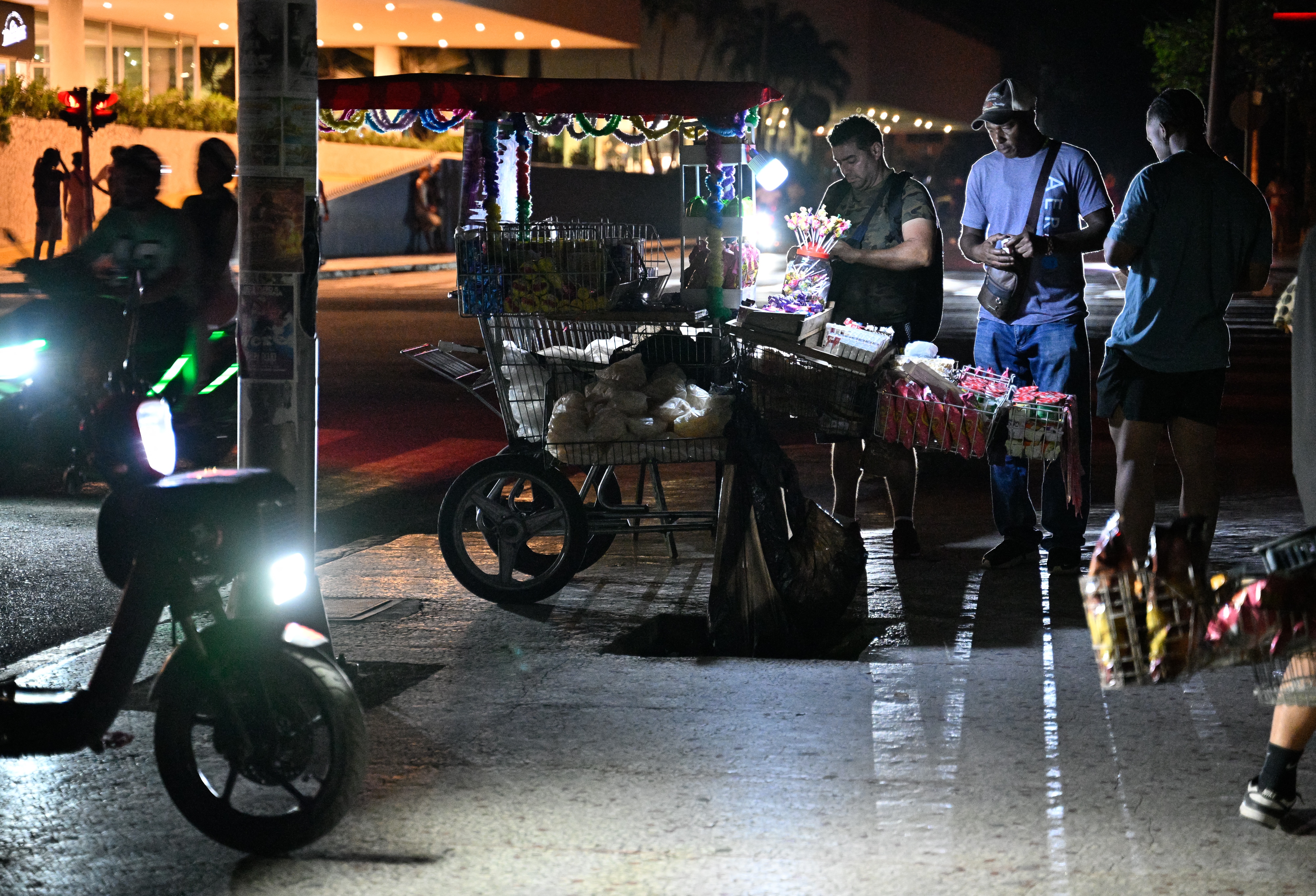 Um vendedor ambulante atende clientes durante um apagão em Havana