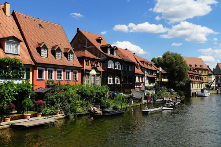 A beautiful shot of Klein Venedig Bamberg Germany across a river with boats on a cloudy daylight