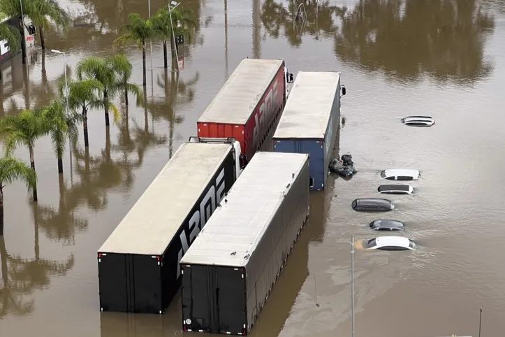 Aerial view of flooded streets at the Sarandi neighborhood in Porto Alegre, Rio Grande do Sul state, Brazil on May 5, 2024. The challenge is titanic and against the clock: authorities and neighbours are trying to avoid an even greater tragedy than the one already experienced in the Brazilian state of Rio Grande do Sul, where 66 people died and 80,000 were displaced by the floods, according to the authorities. (Photo by Florian PLAUCHEUR / AFP)