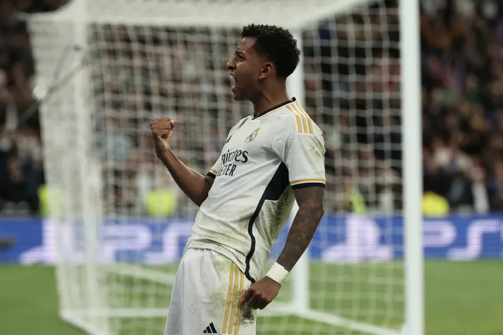 Real Madrid's Brazilian forward #11 Rodrygo celebrates scoring his team's fifth goal during the Spanish league football match between Real Madrid CF and Valencia CF at the Santiago Bernabeu stadium in Madrid on November 11, 2023. (Photo by Thomas COEX / AFP)