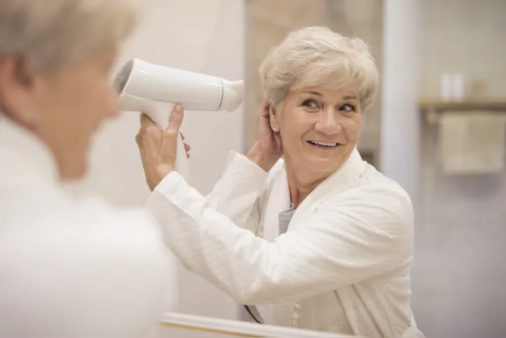 Attractive senior woman in the bathroom