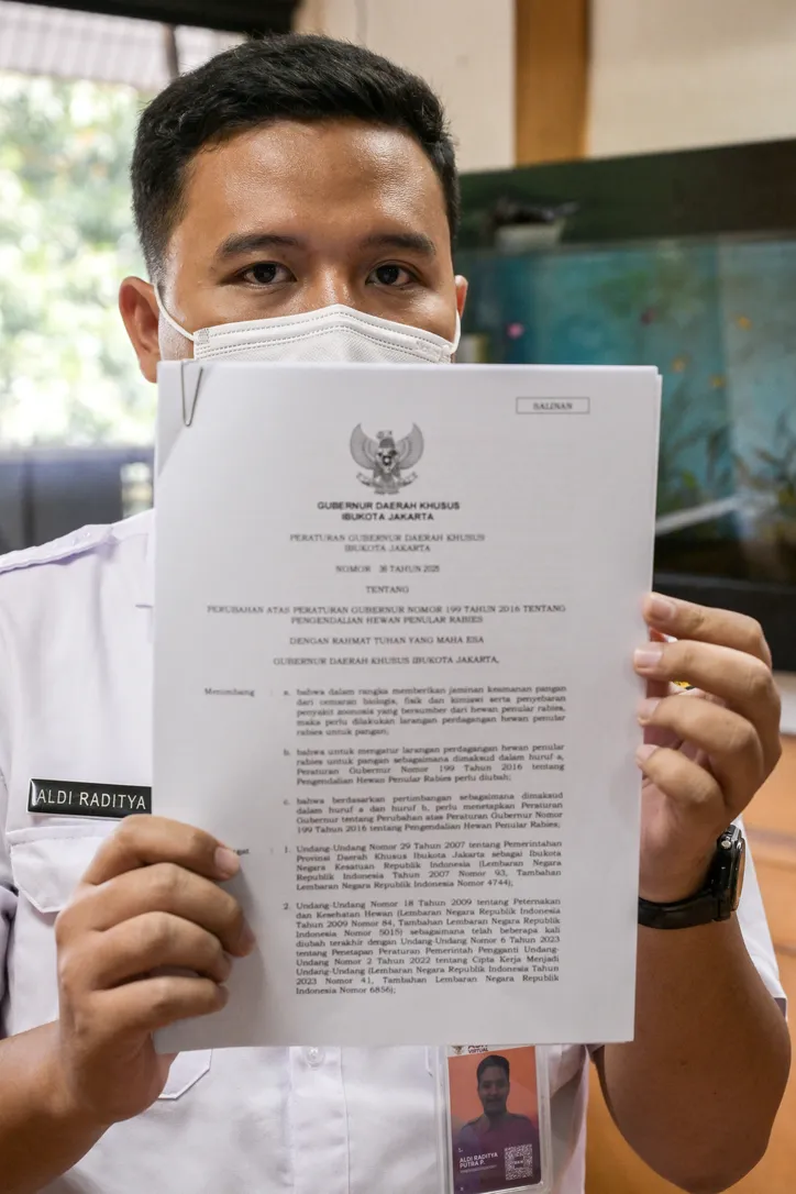 Funcionário da agência de resiliência alimentar, marítima e agrícola de Jacarta exibe decreto