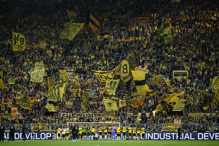 Jogadores do Dortmund comemoram em frente à torcida no muro amarelo da arquibancada sul após a partida do Campeonato Alemão